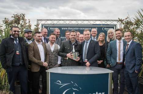 MKM Branch Director Glenn Paddison is pictured presenting the trophy to Charlie along with Hannah, Liz and the rest of the team from the MKM branch.